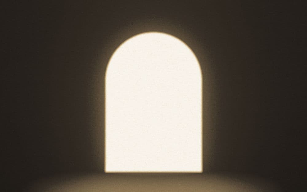 An arched opening filled with dusk light.