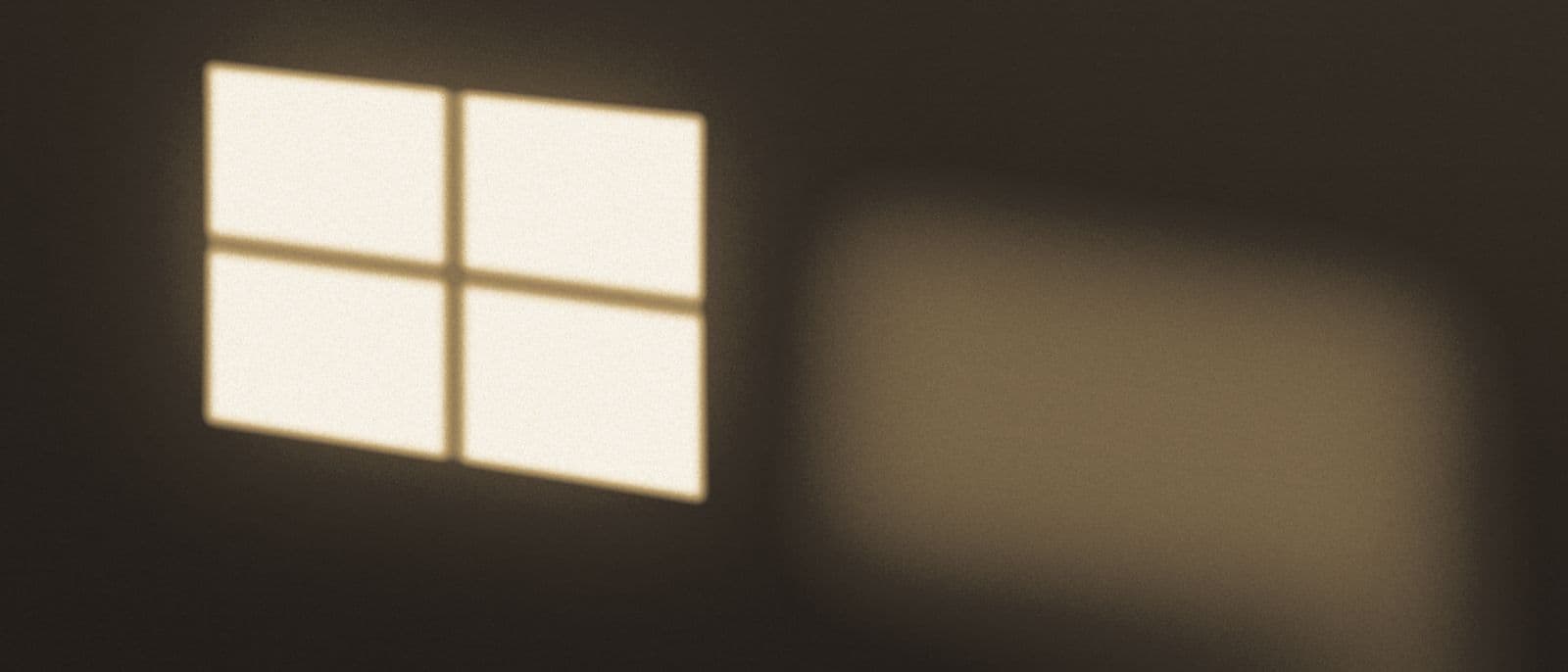 Low evening light falling through a window across a quiet room.