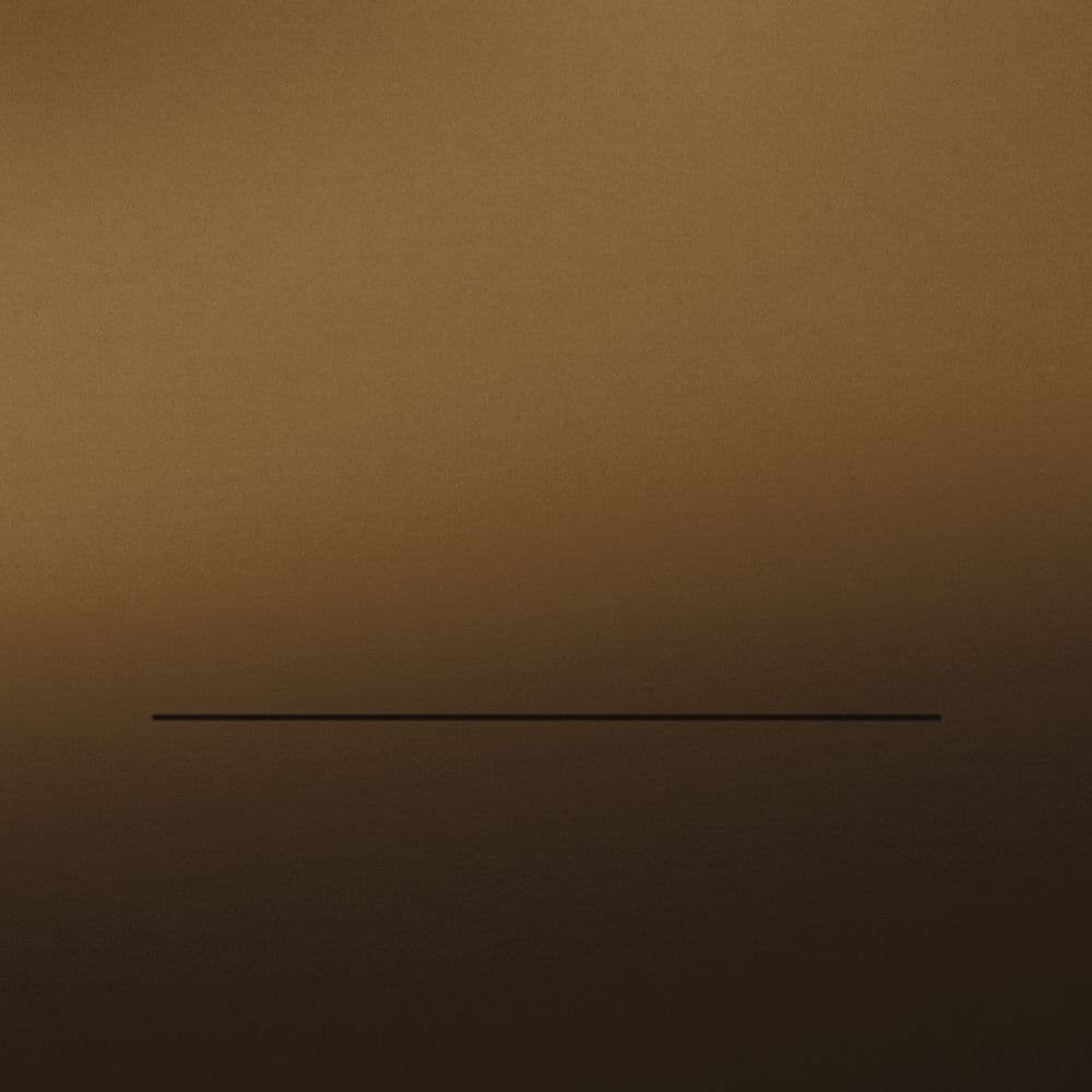 A dark, warm sleeve with a slow band of light and a single rule.