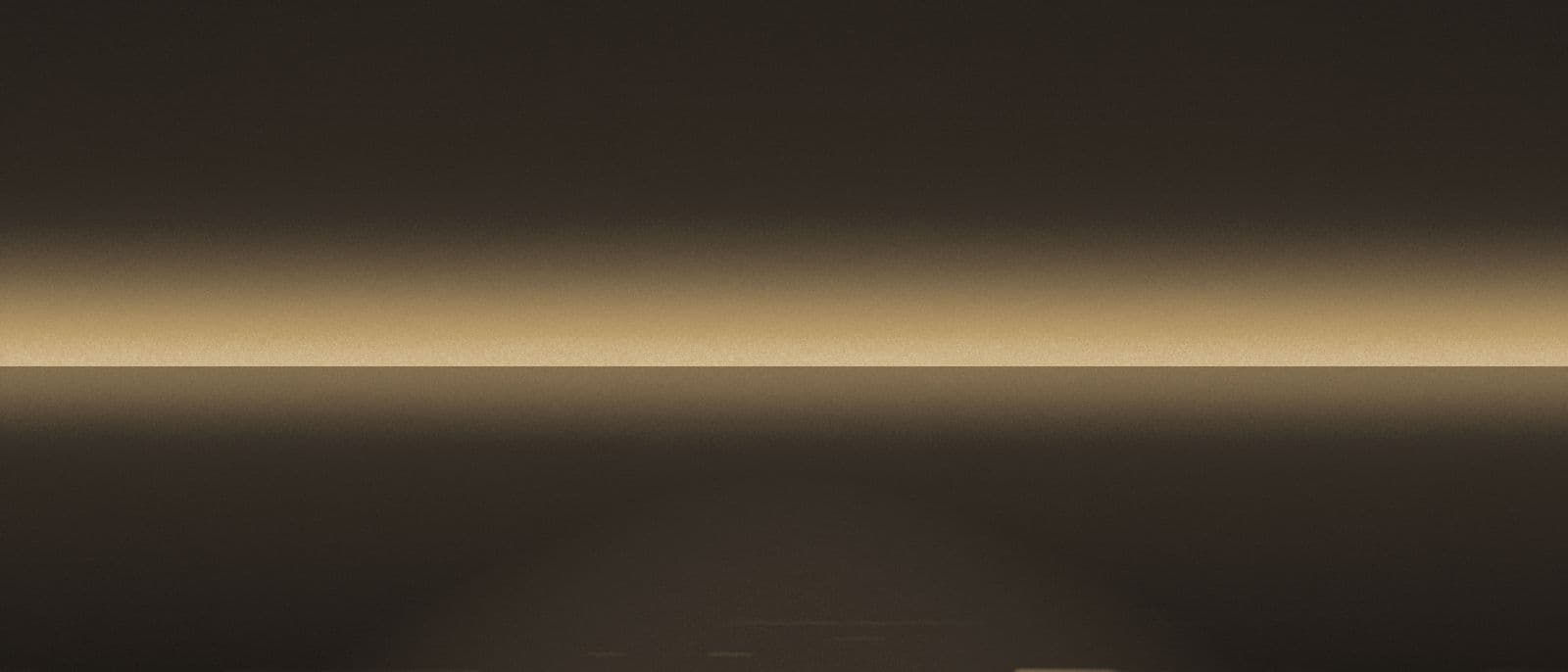 A wide dusk horizon with light broken across the water.