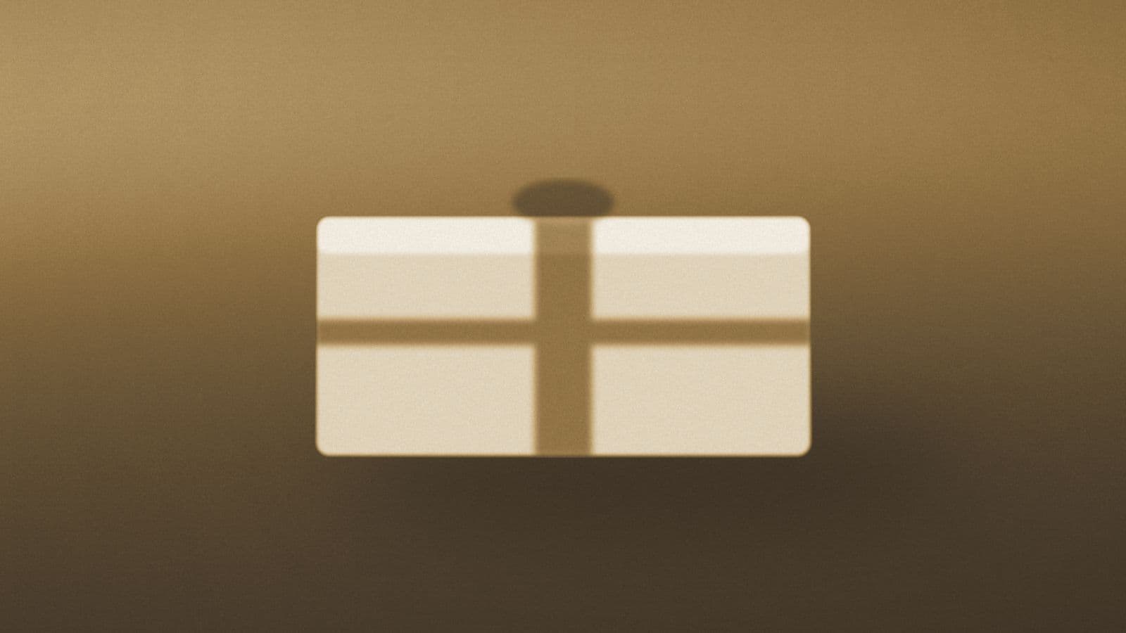 A ribboned parcel resting on a warm table in soft light.