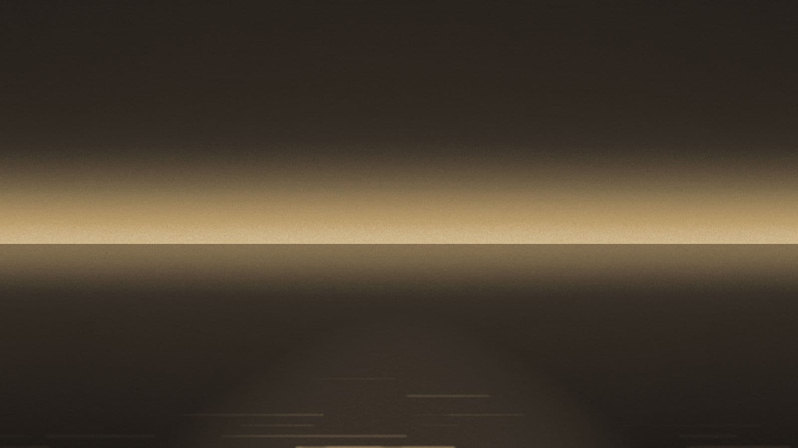 A low horizon at dusk with a path of light reflected across still water.