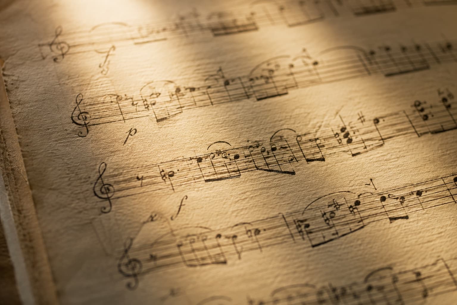 Three staves of hand-written music on aged paper.