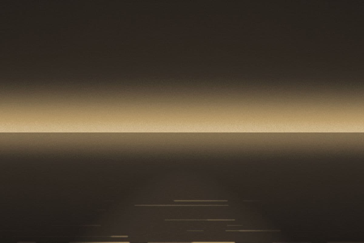 A low horizon at dusk with light broken across the water.
