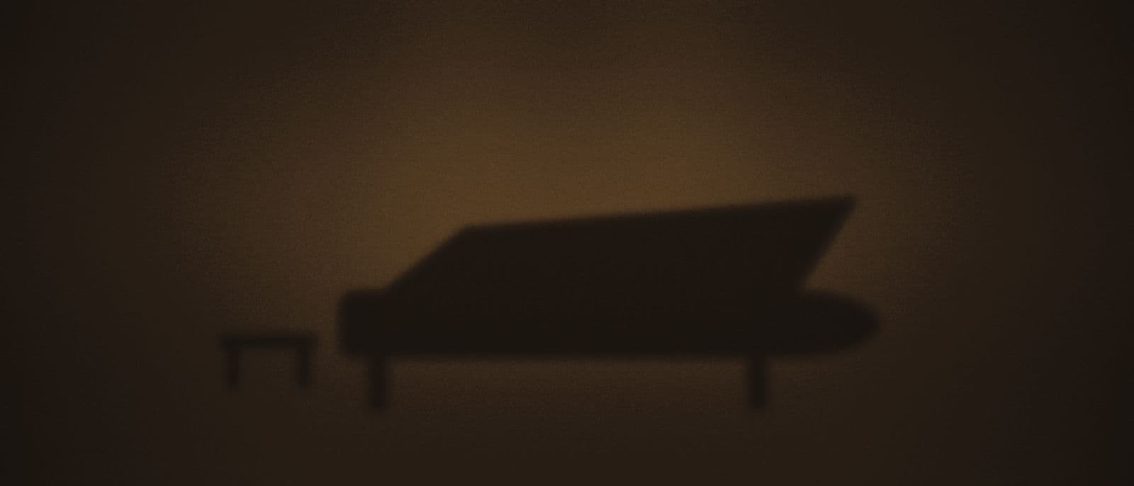 A grand piano waiting in a pool of stage light.